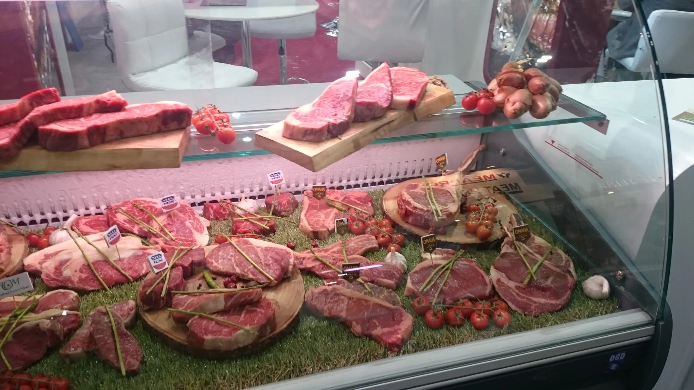 A butcher’s display counter with many cuts of lamb and beef