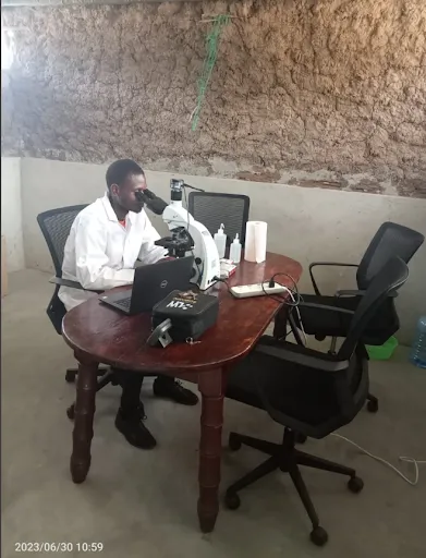 A soil lab technician at a microscope